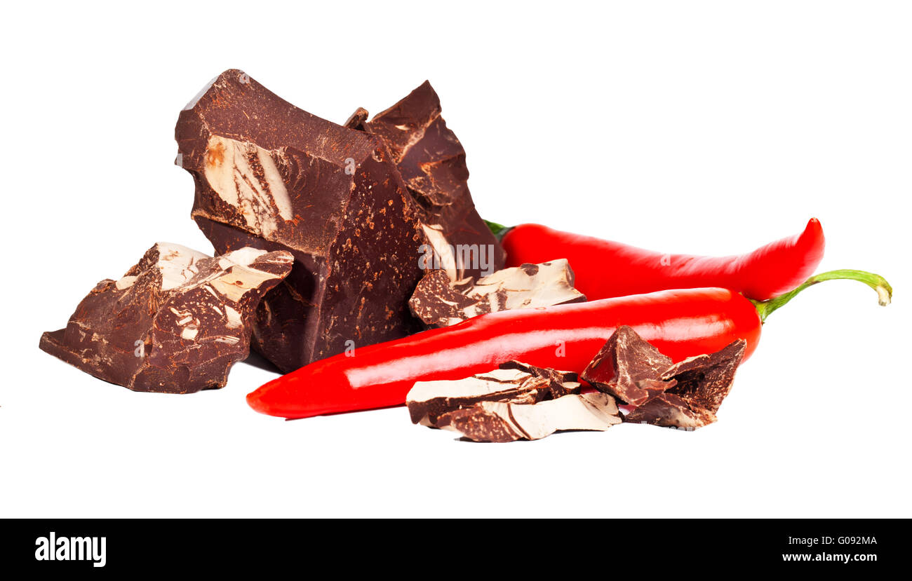 Heap of delicious black chocolate with two red chili peppers Stock Photo
