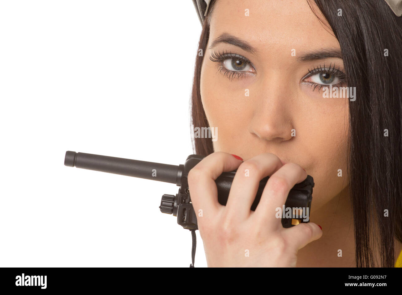 serious female construction worker talking with a walkie talkie Stock Photo