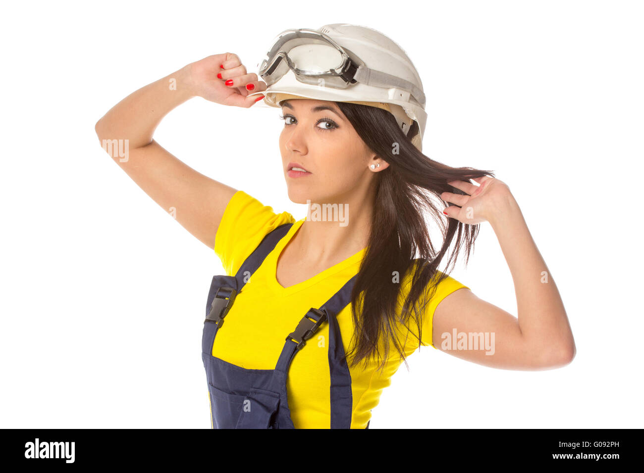 Serious female construction worker in helmet with goggles Stock Photo