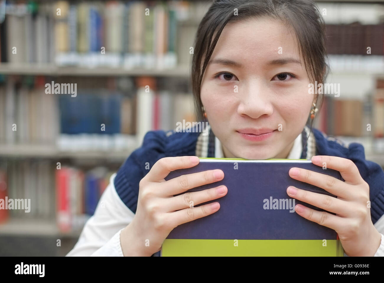 Student resting her chin on textbook Stock Photo Alamy