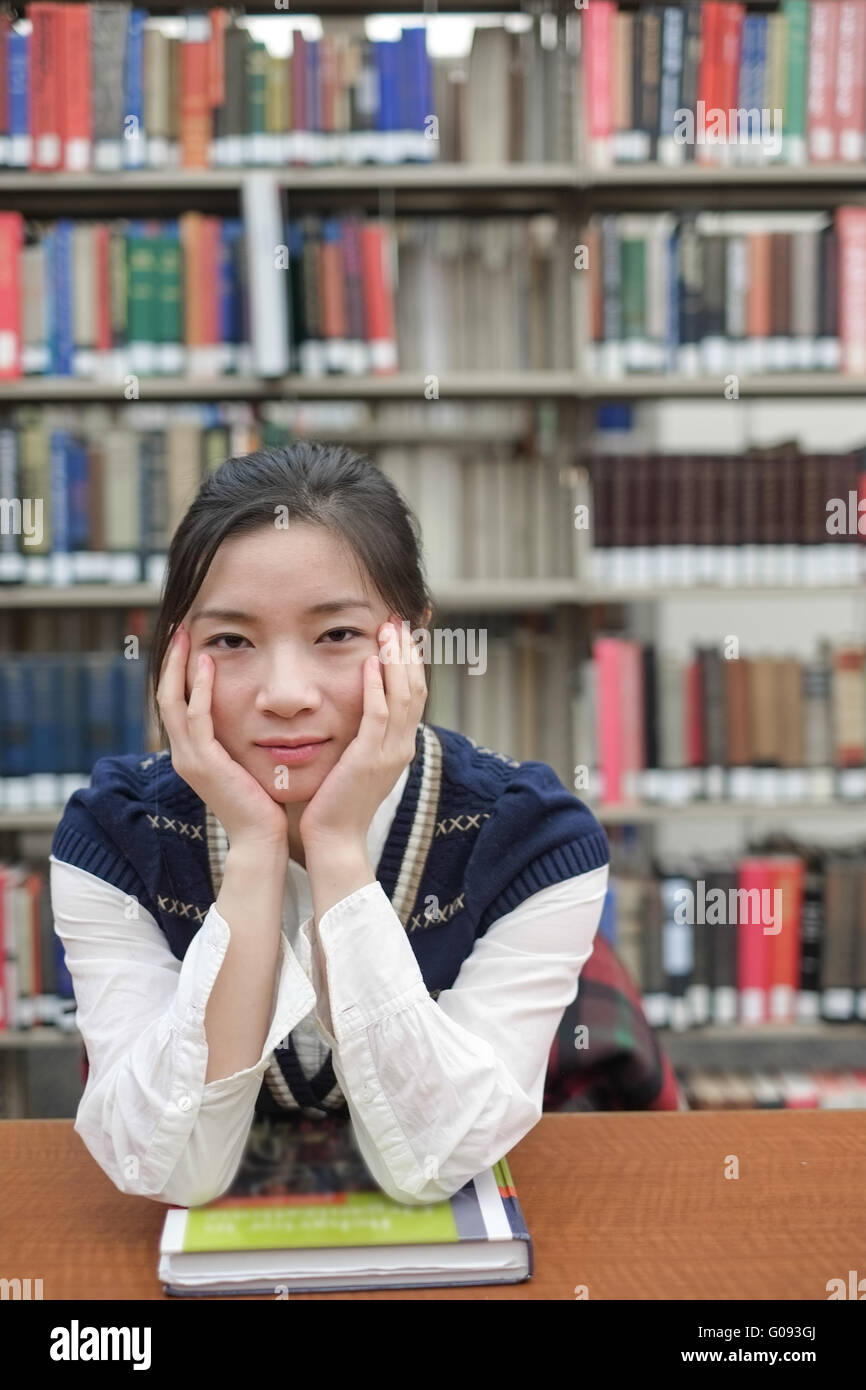 Student sitting at a desk near library Stock Photo - Alamy