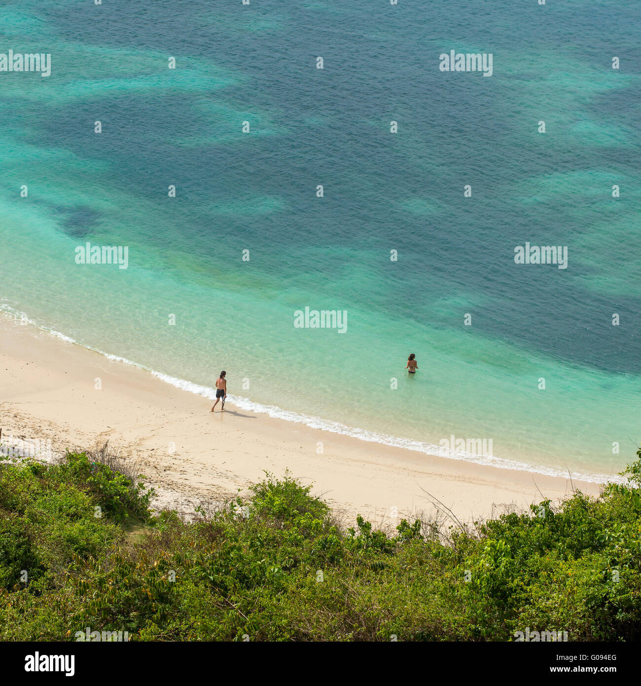 Couple swimming in the turquoise sea on the beautiful tropic beach Stock Photo