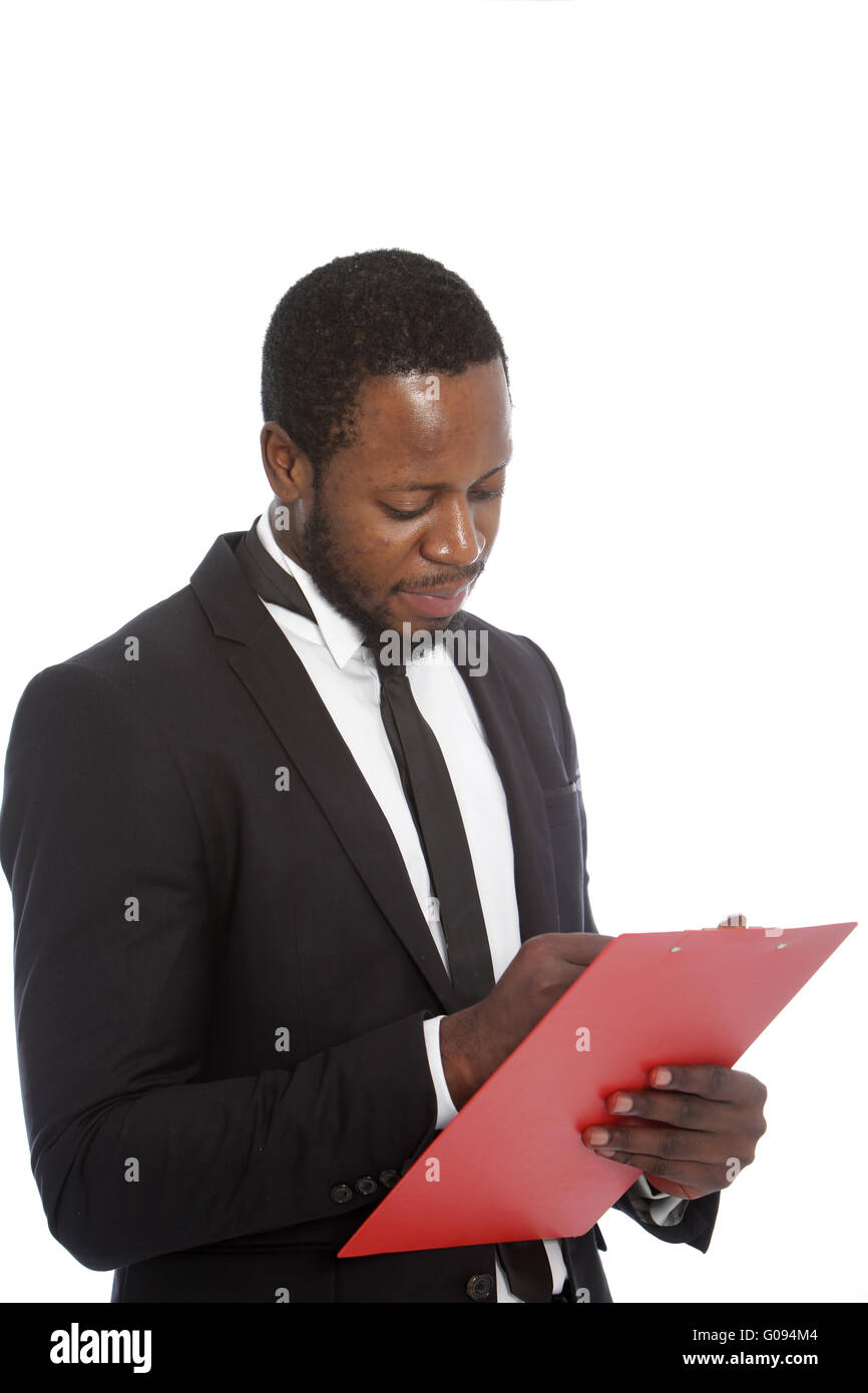 African businessman writing notes on a clipboard Stock Photo - Alamy