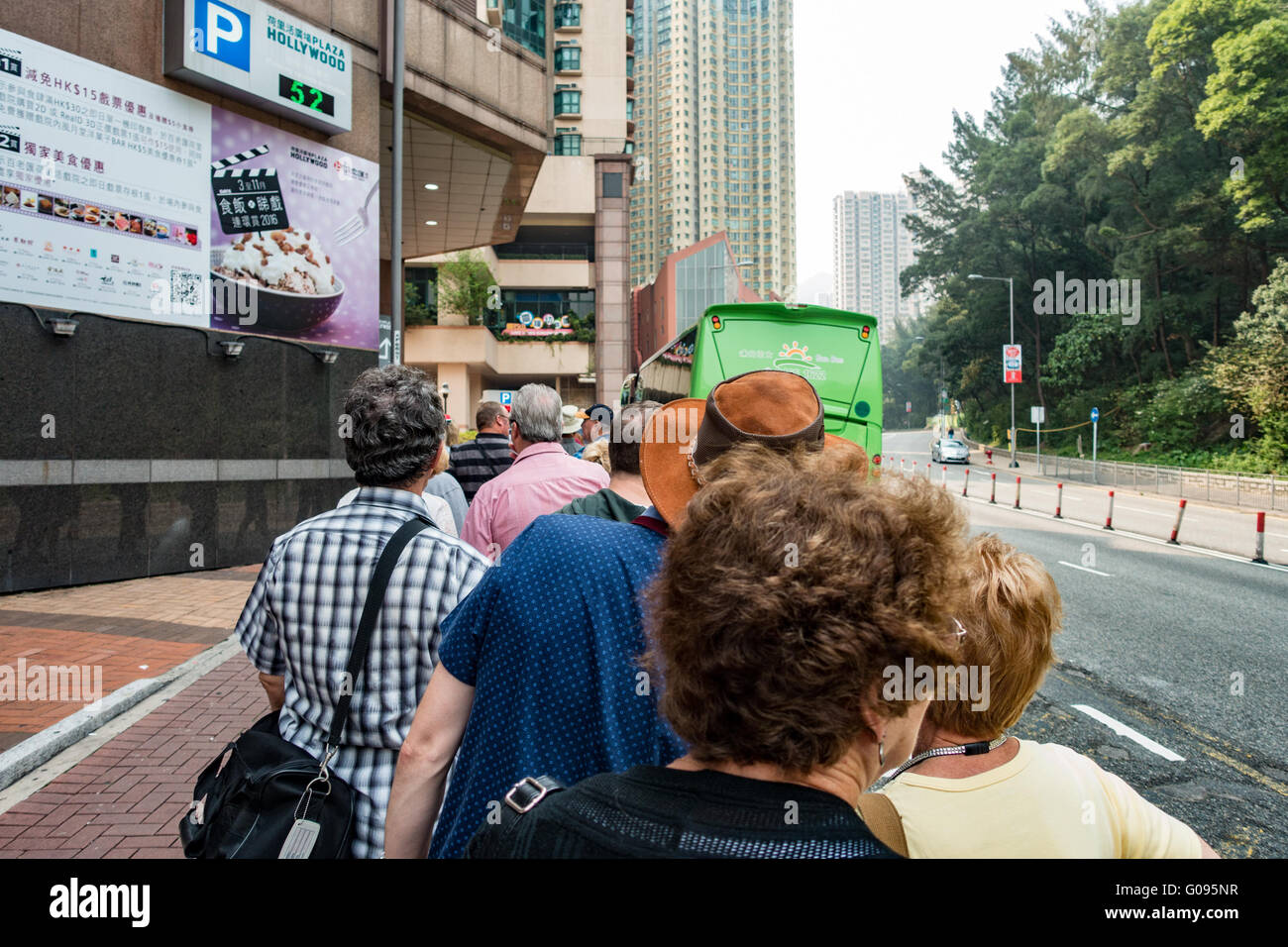 Tourists line up to board courtesy bus at Hollywood Plaza shopping centre in Hong Kong Stock Photo