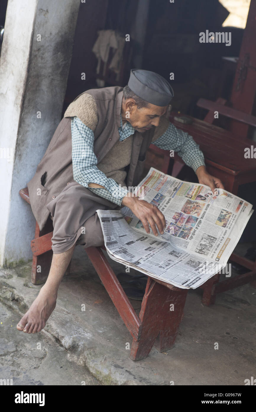 Traditional indian man is reading newspaper, India Stock Photo