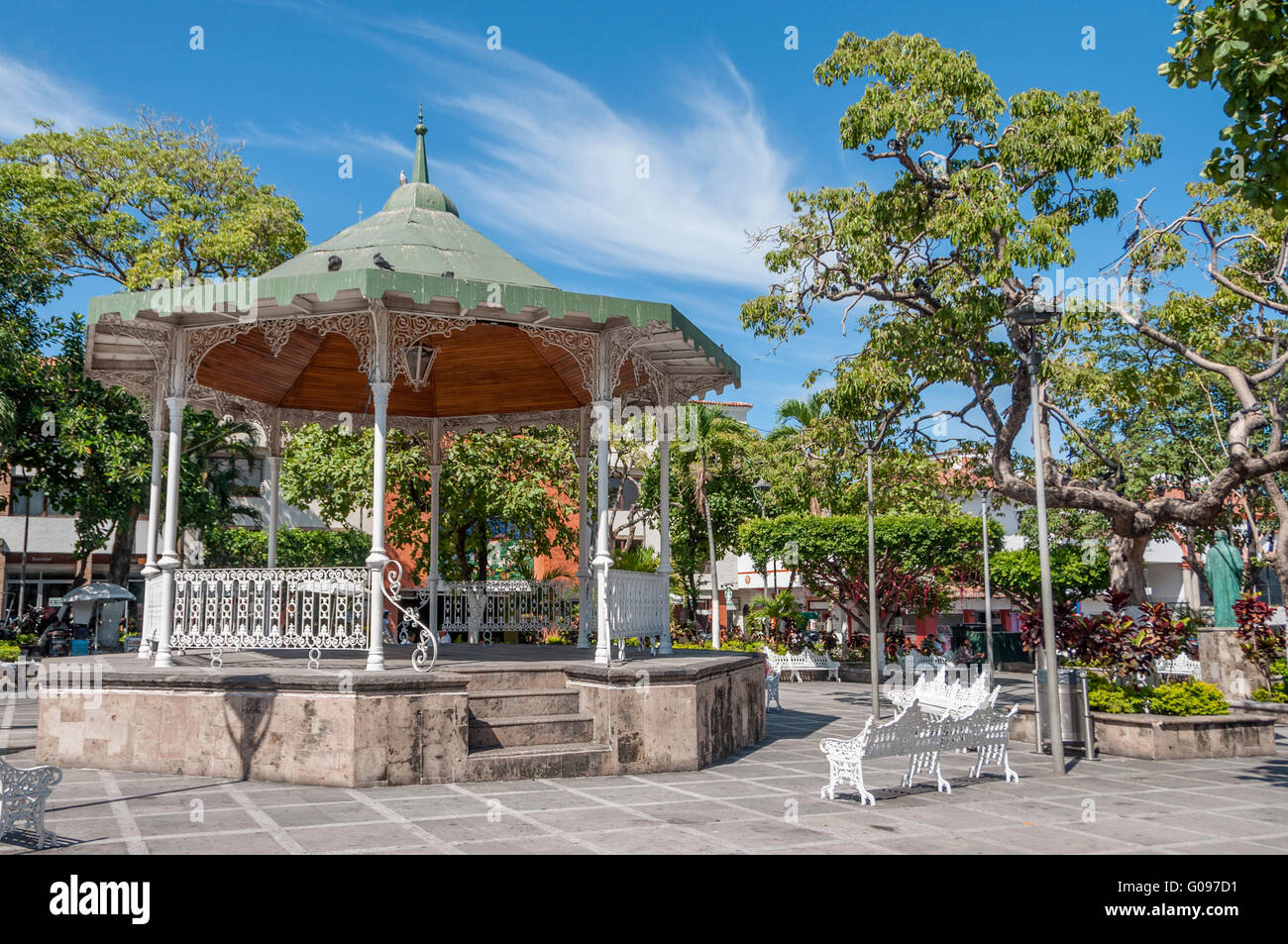 Gazebo bandstand in Plaza Principal, Old Town Puerto Vallarta, White wrought iron park benches in Zona Romantica, the town square city center. Stock Photo