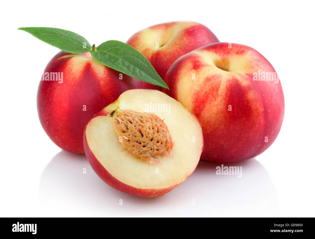 Three ripe peach (nectarine) fruits with slices isolated Stock Photo