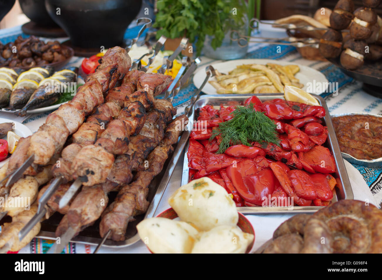 Meat and fish dishes with vegetables on the table. Stock Photo