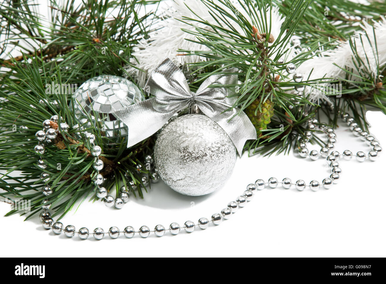 Christmas firtree branch with silver balls, beads and ribbon Stock Photo