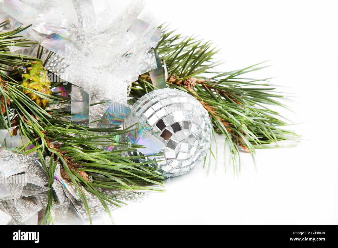 Fir tree branch with Christmas ball and shiny tinsel Stock Photo