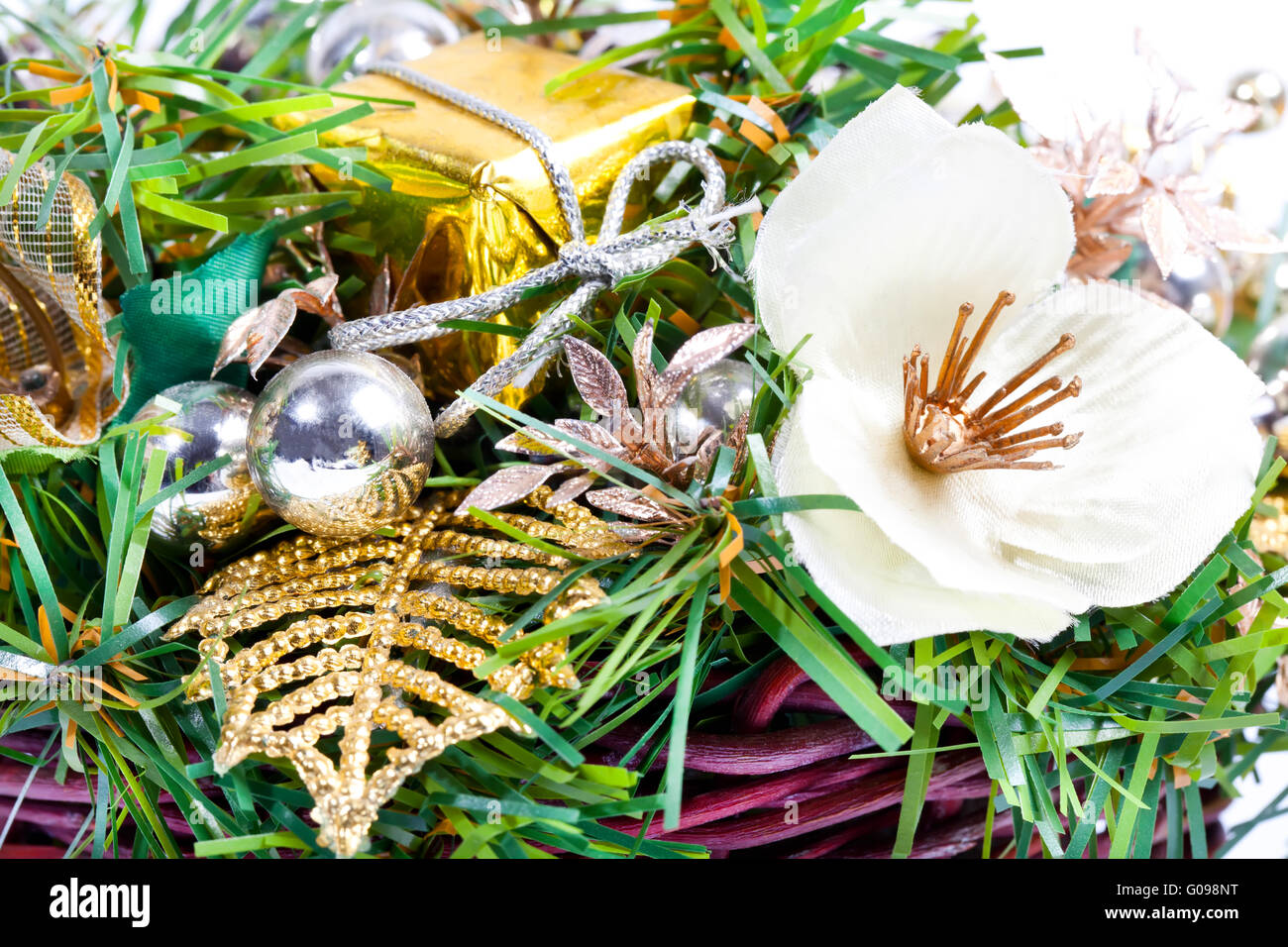 New Year composition with flower, leaves and beads in basket Stock Photo