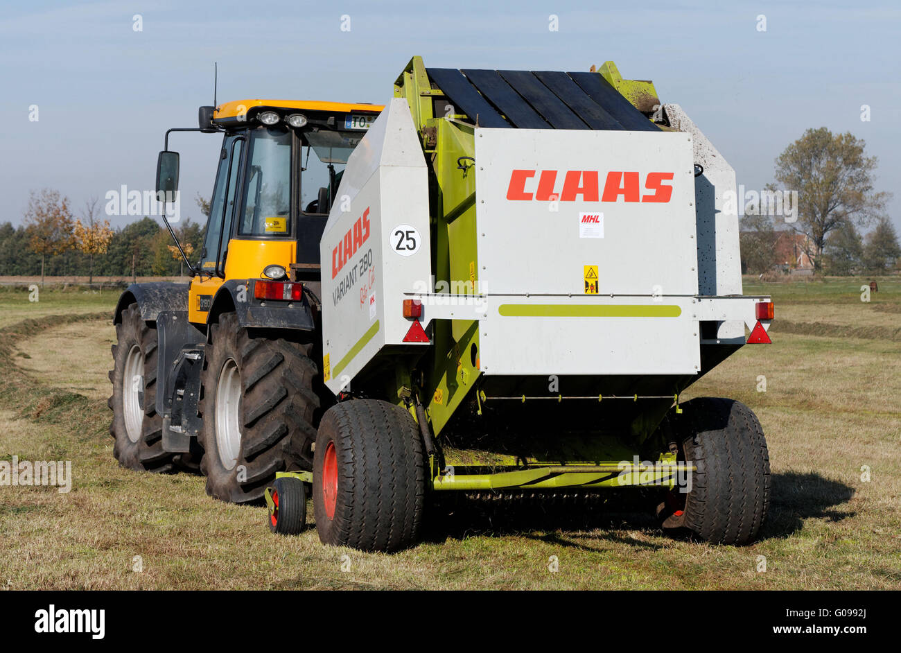 Press tractor with the hay harvest in Dautschen. Stock Photo
