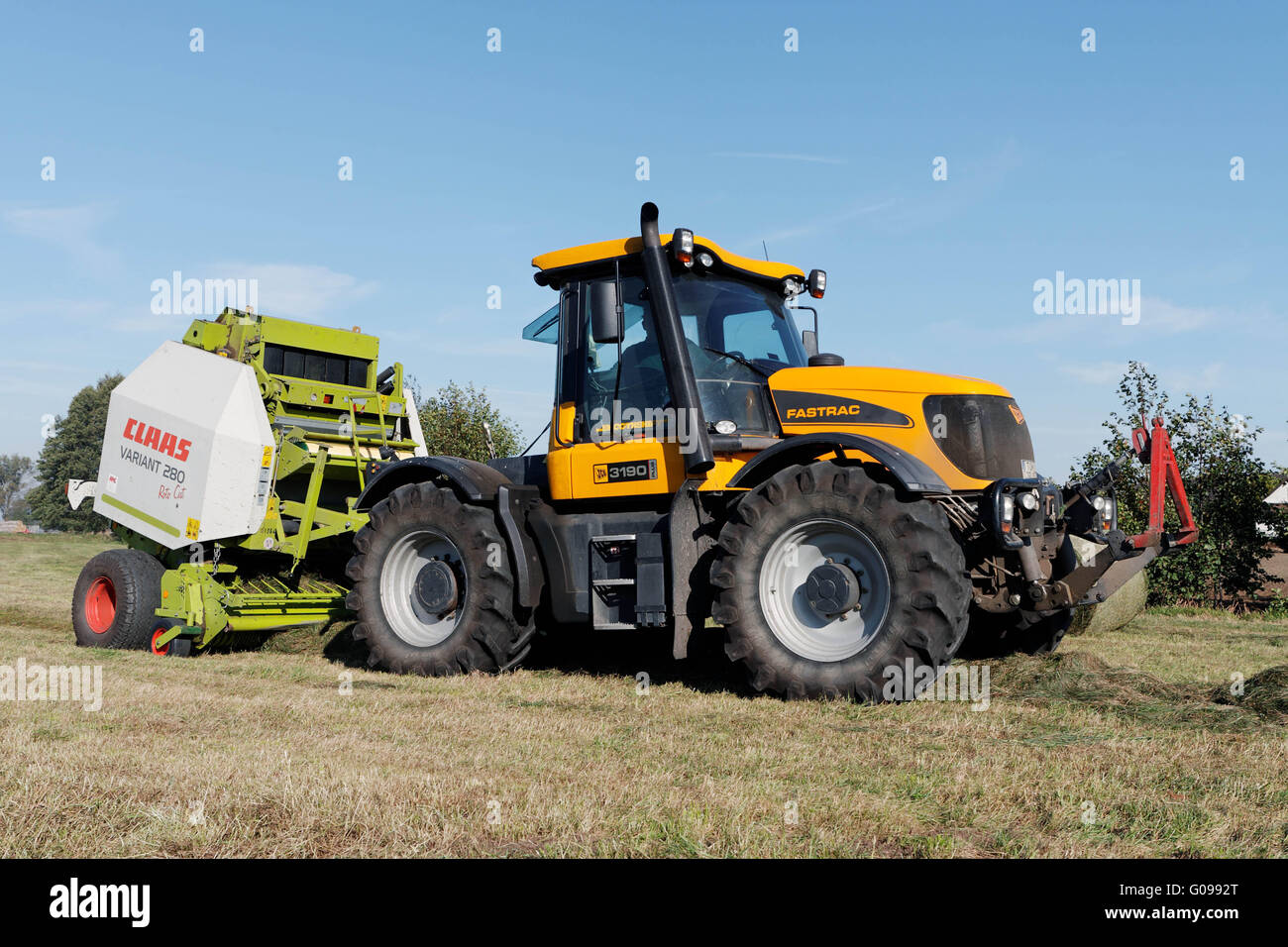 Press tractor with the hay harvest in Dautschen. Stock Photo