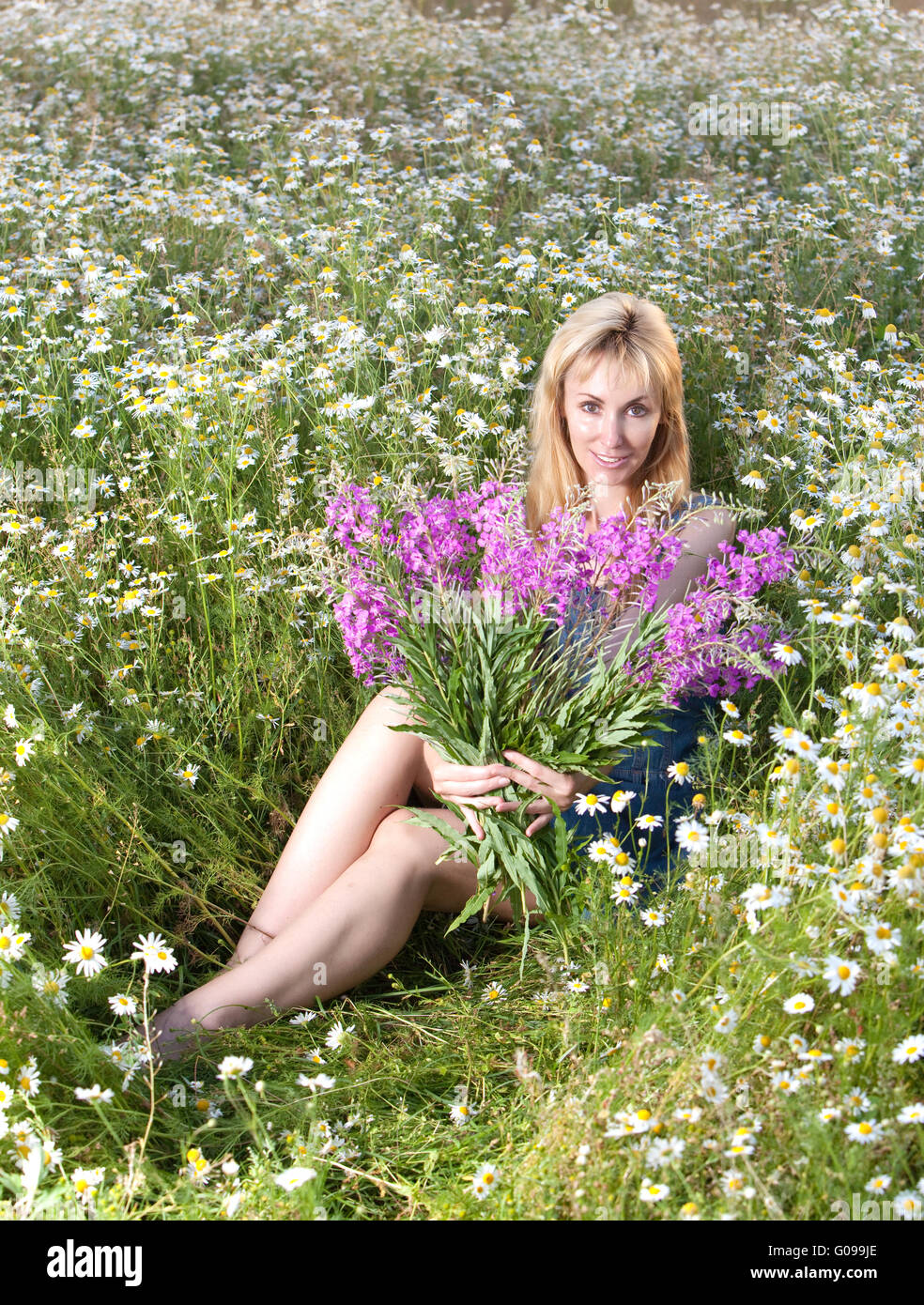 woman with bunch of willowherb flower in the field Stock Photo