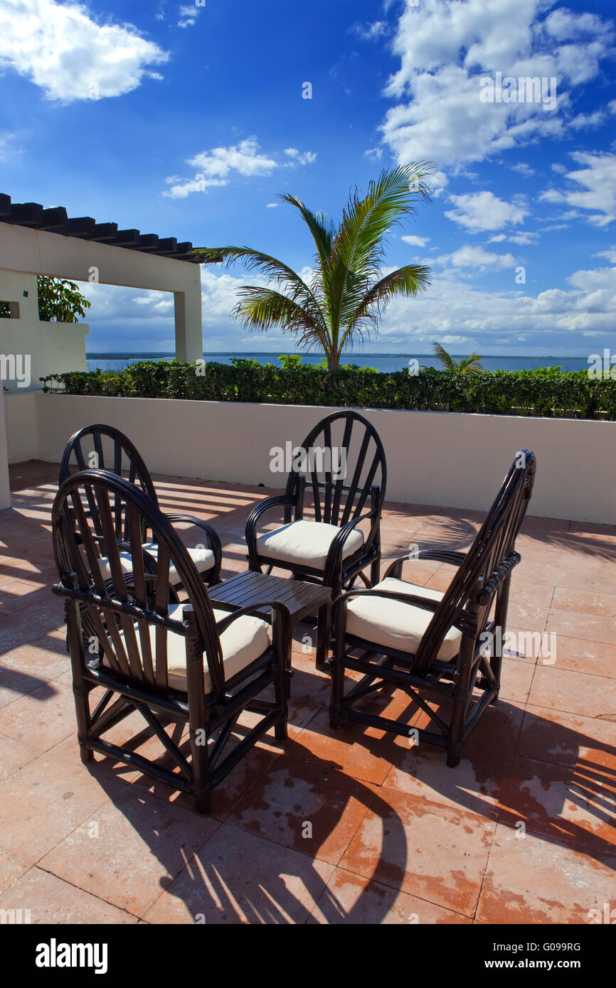 Chairs and little table on a tropical terrace over Stock Photo Alamy