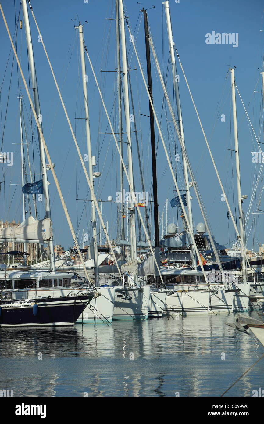 Masts and rigging of yachts moored in harbour Stock Photo
