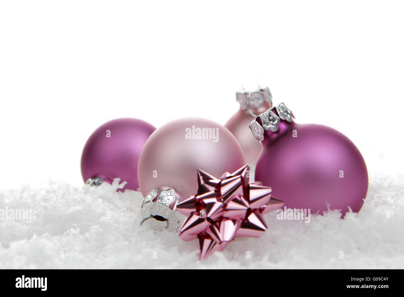 pink christmas balls with loop on artificial snow Stock Photo