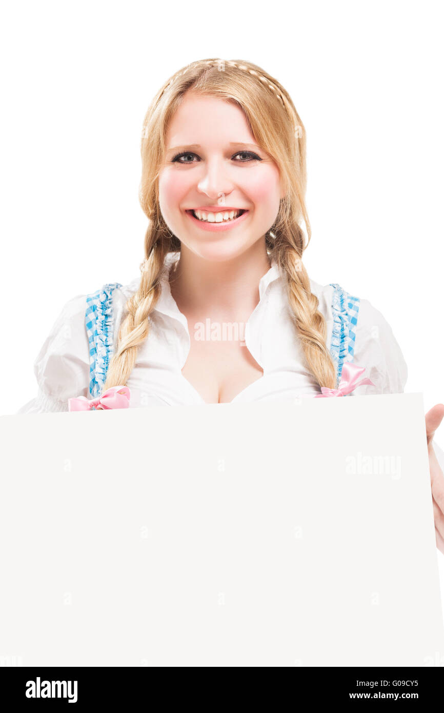 Bavarian woman in dirndl, holding blank signboard. Stock Photo