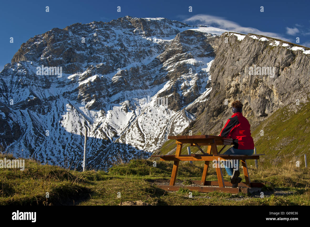 Hiker taking a rest beneath a peak,Switzerland Stock Photo