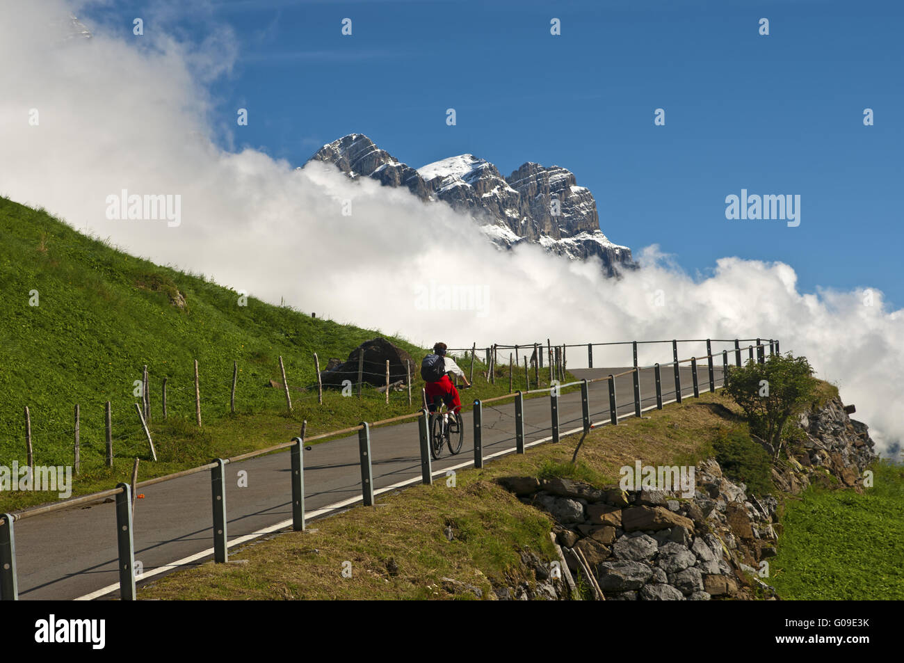 Biker on the mountain road to the pass Klausenpass Stock Photo