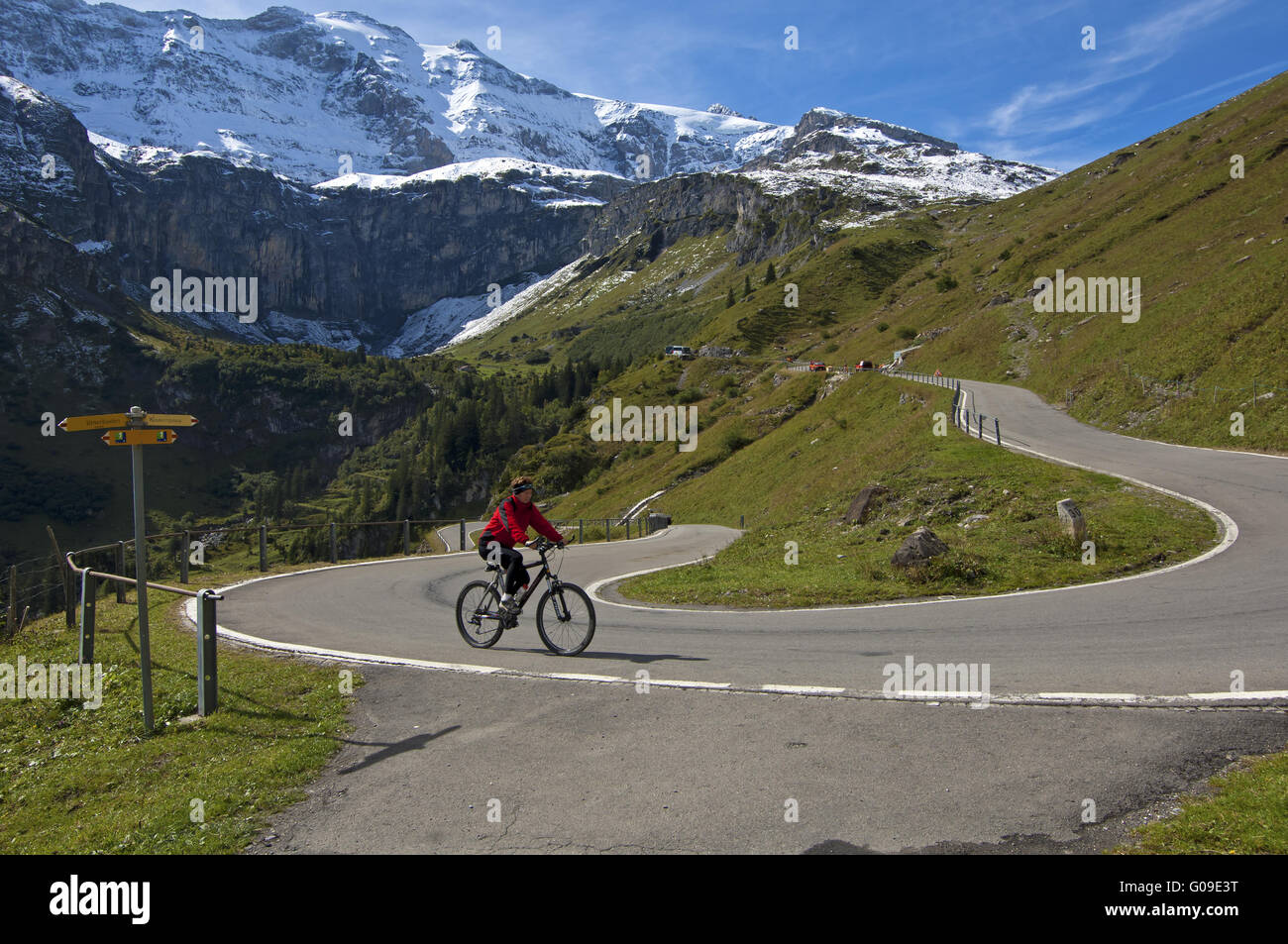 Biker pedaling through a hairpin bend,Switzerland Stock Photo