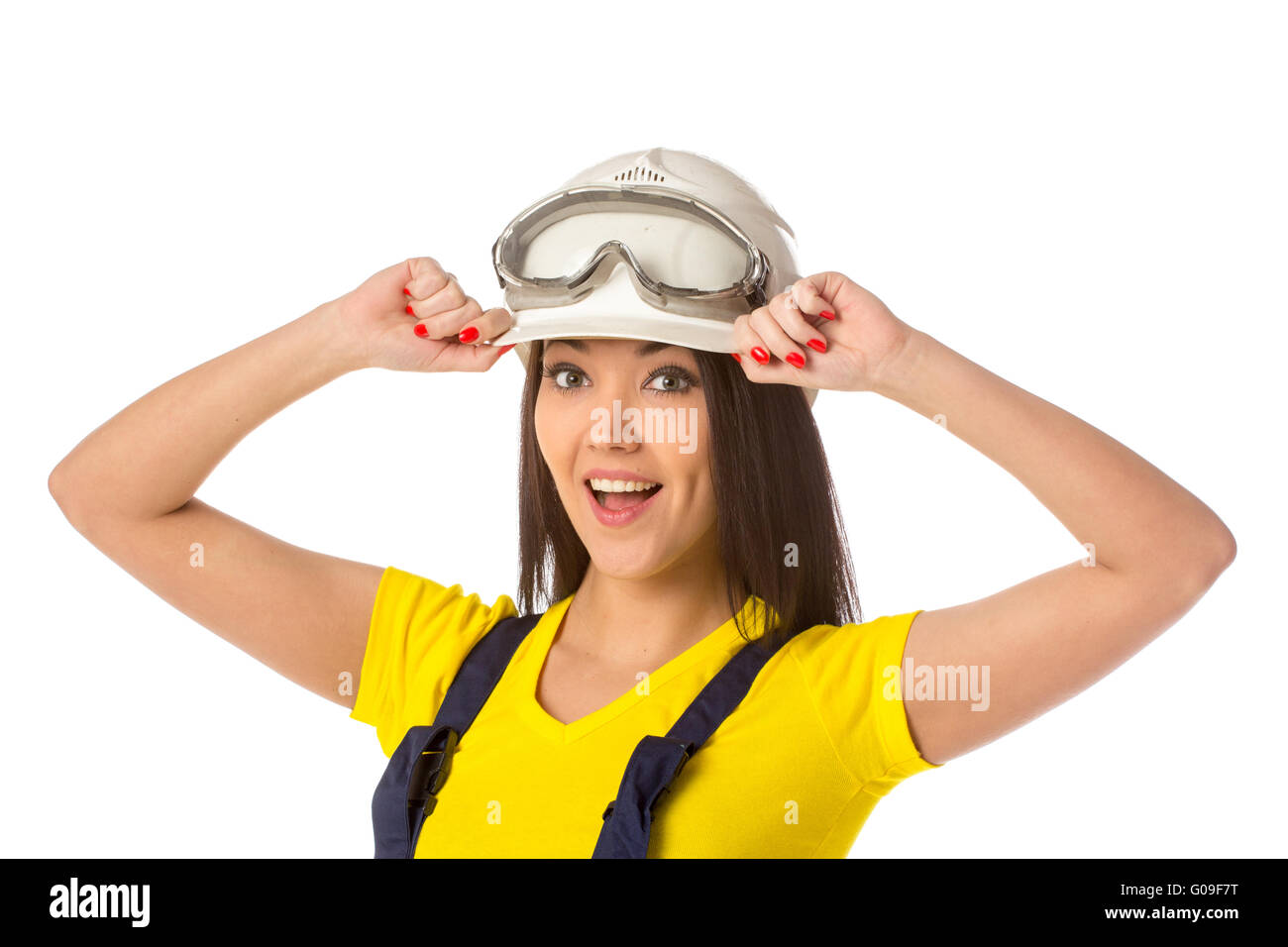 Serious female construction worker in helmet with goggles Stock Photo