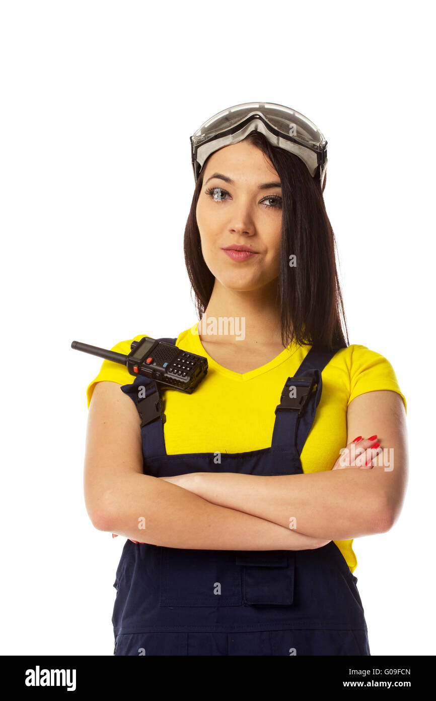 serious female construction worker talking with a walkie talkie Stock Photo