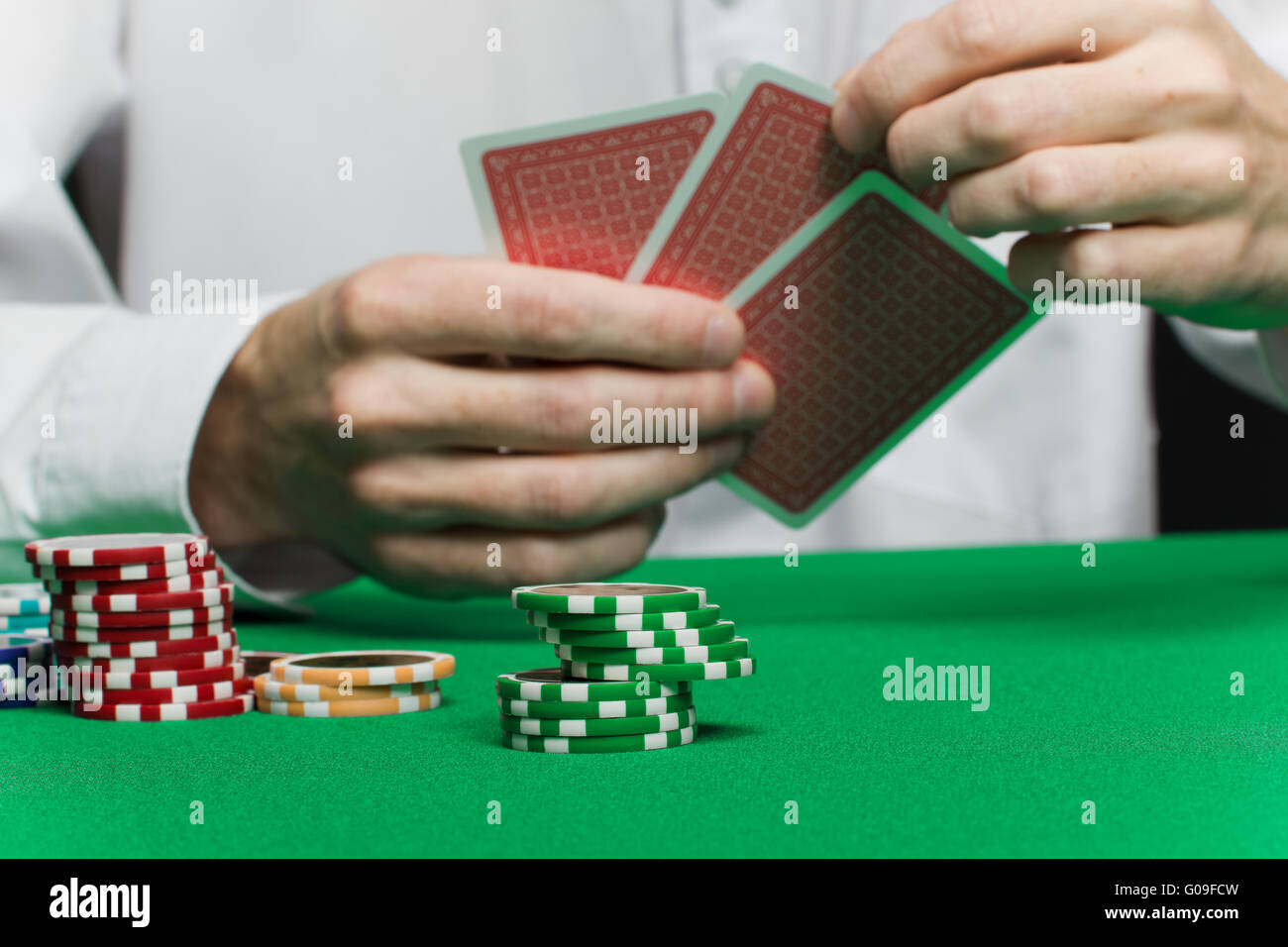 poker chips and the player's hand with the cards Stock Photo Alamy