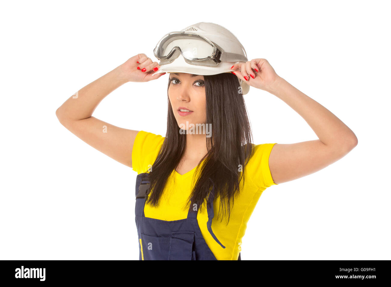 Serious female construction worker in helmet with goggles Stock Photo