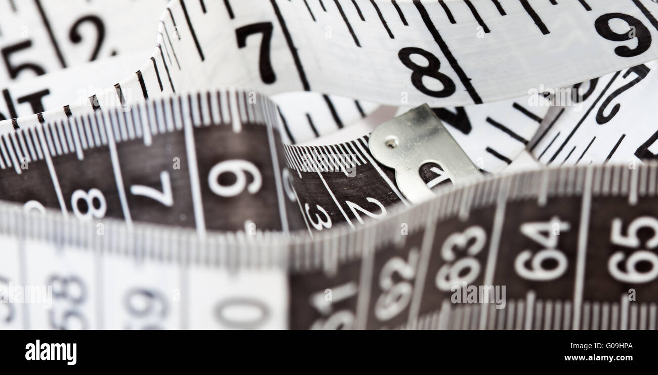 Measuring tape, symbol of tailoring and diets Stock Photo