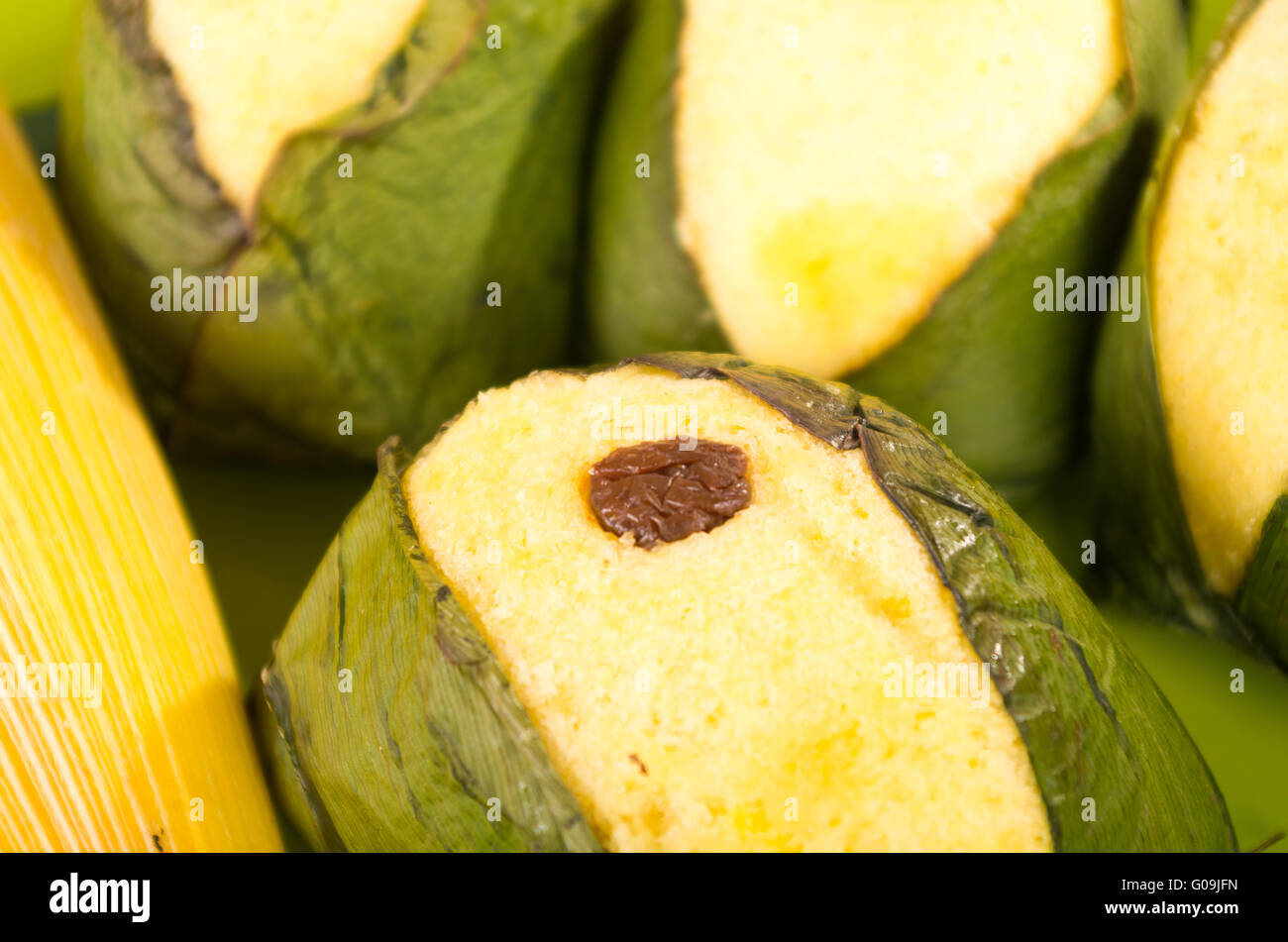 Quimbolito, traditional ecuadorian food made of flour and egg with raisin and rolled in achira leaf Stock Photo