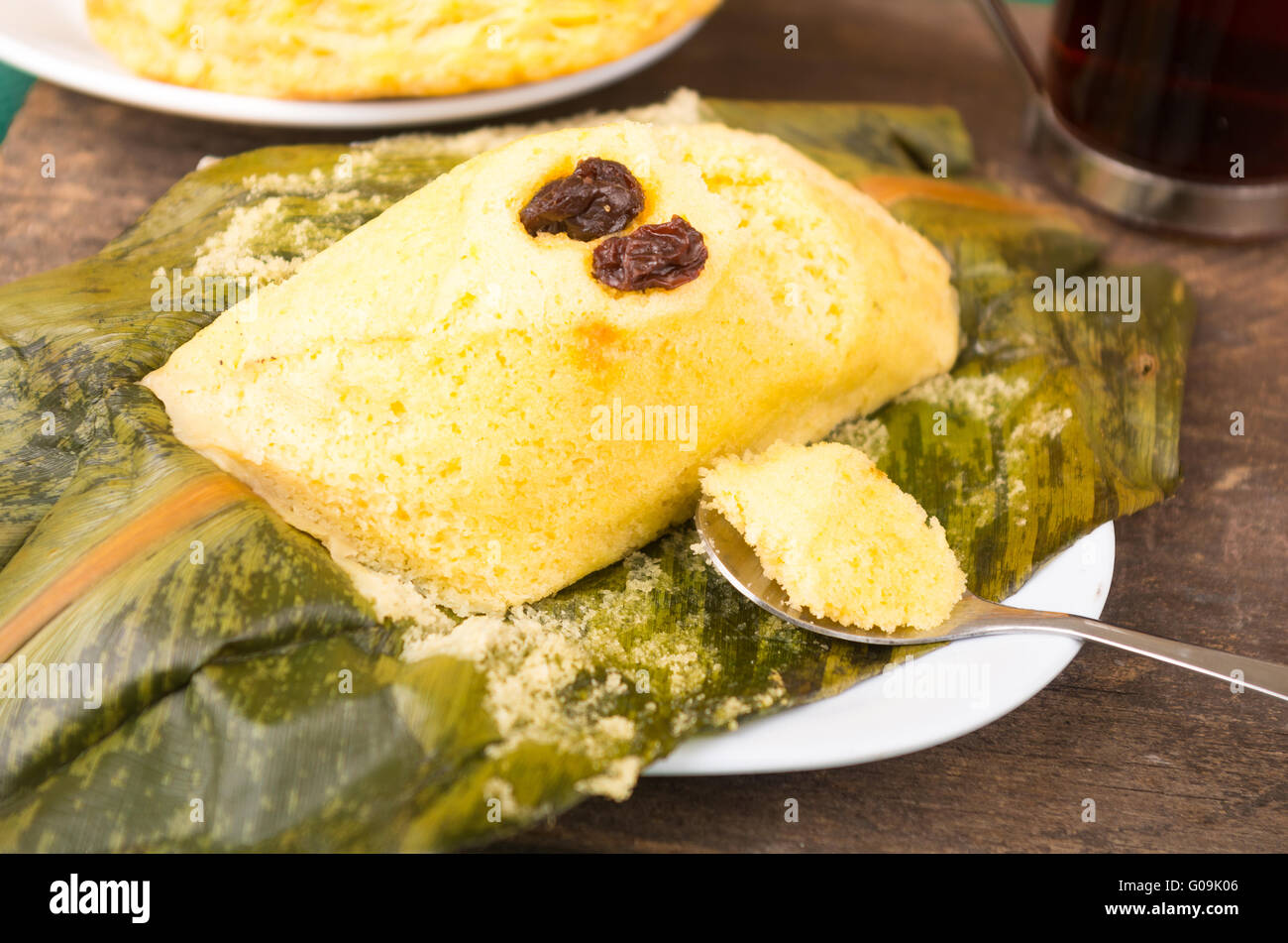 Little metal spoon take a piece of quimbolito, traditional ecuadorian food Stock Photo