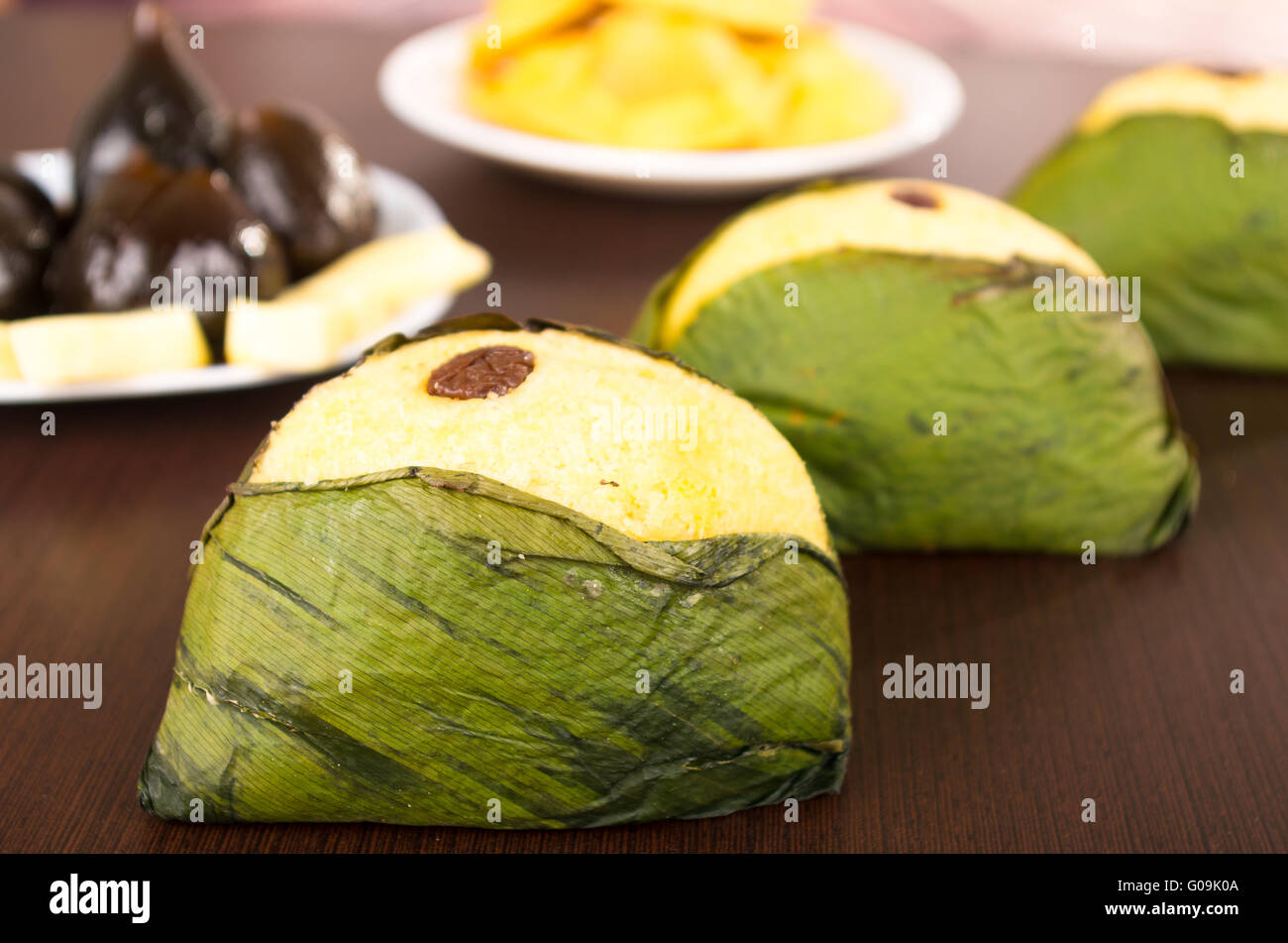 Wrapped quimbolito, sweet dough on achira leaf and raisins served on a white dish Stock Photo