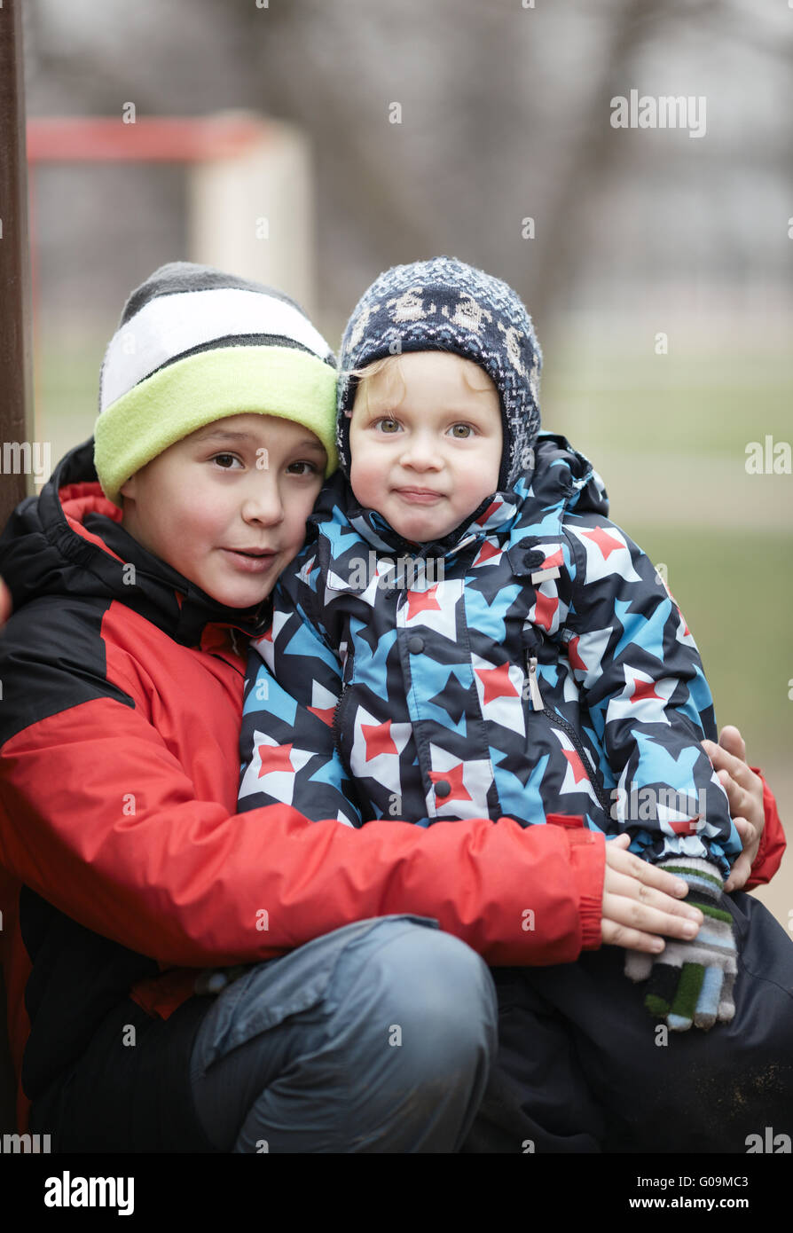 Two adorable young brothers outdoors in winter Stock Photo