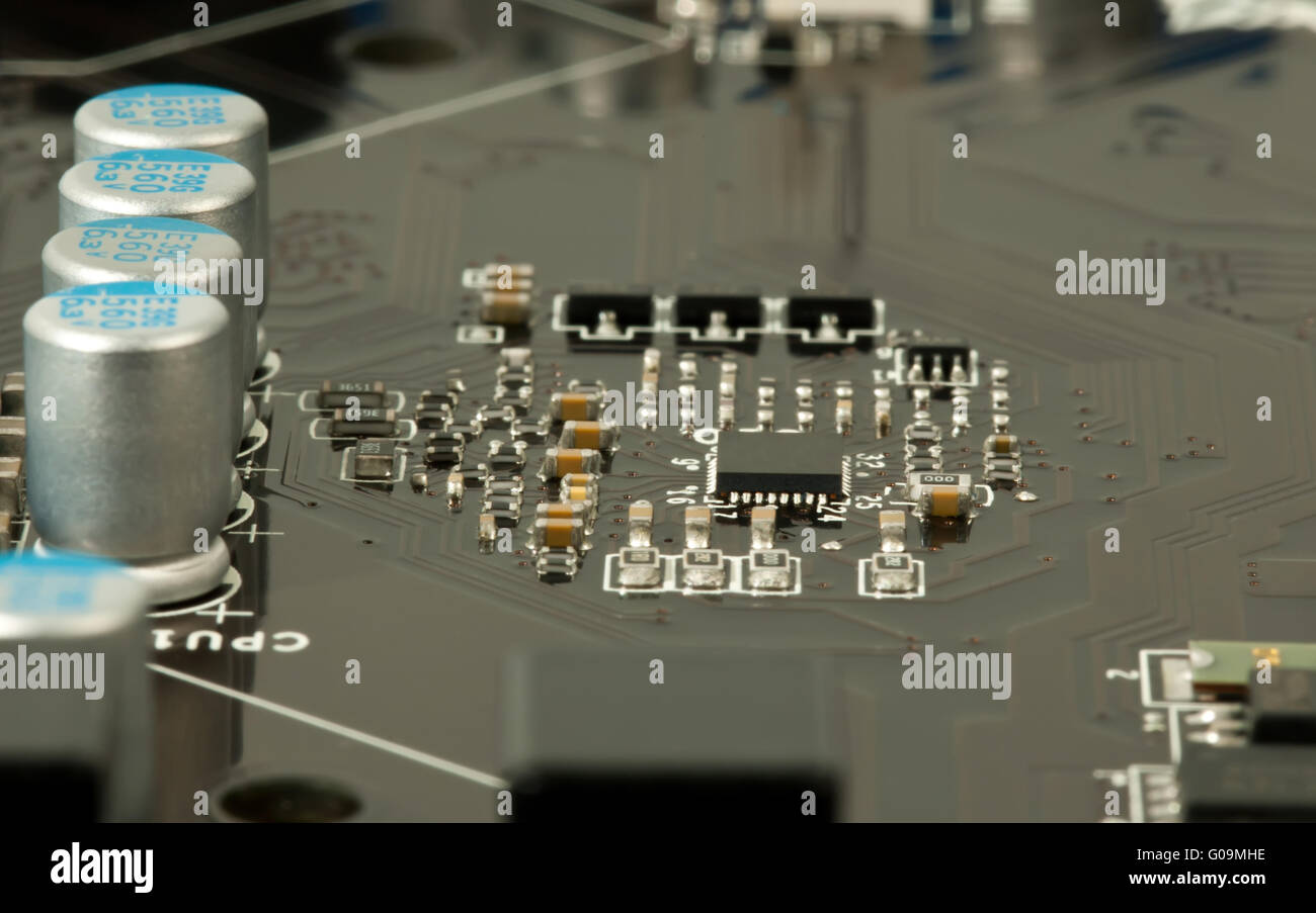 Laptop microchip and conductors on mother board closeup Stock Photo