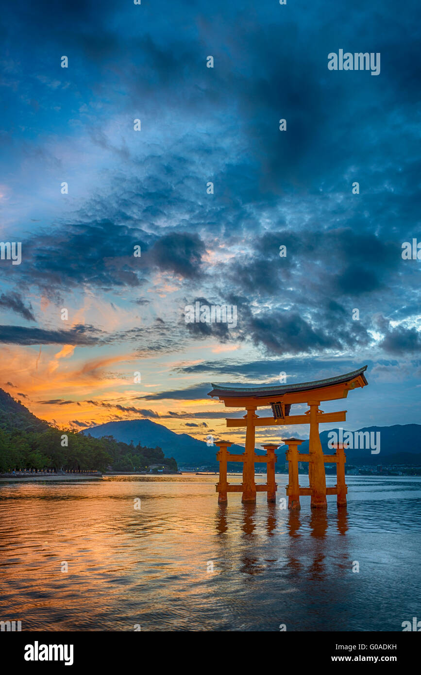 Sunset at the famous floating torii gate of the Itsukushima Shrine on Miyajima at high tide Stock Photo