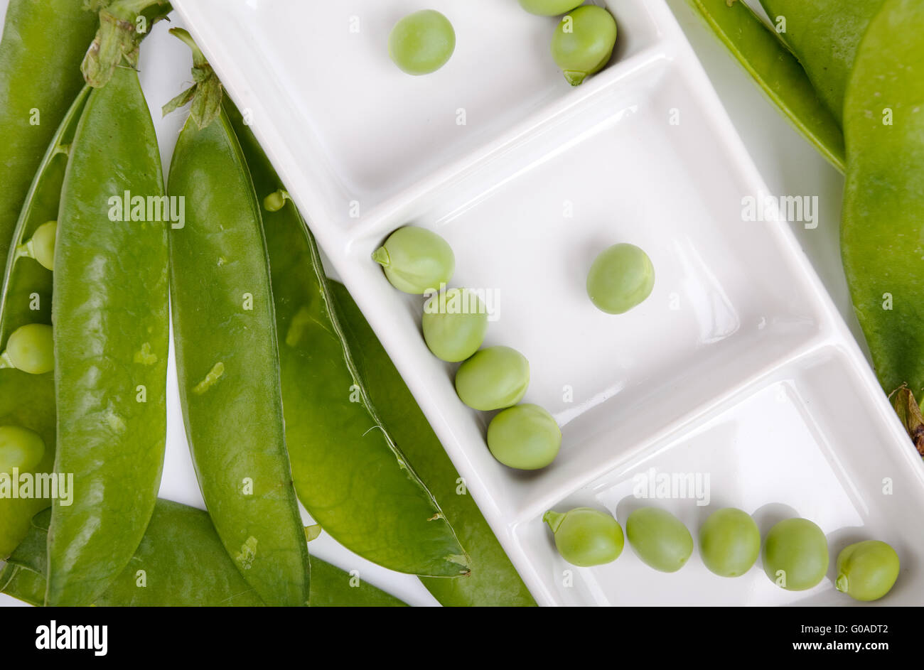 Fresh and dried Peas on white Background Stock Photo