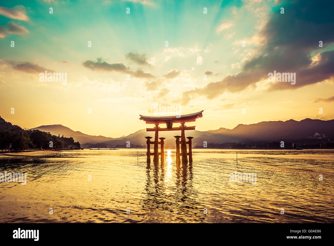 Sunset at the famous floating torii gate of the Itsukushima Shrine on Miyajima at high tide Stock Photo