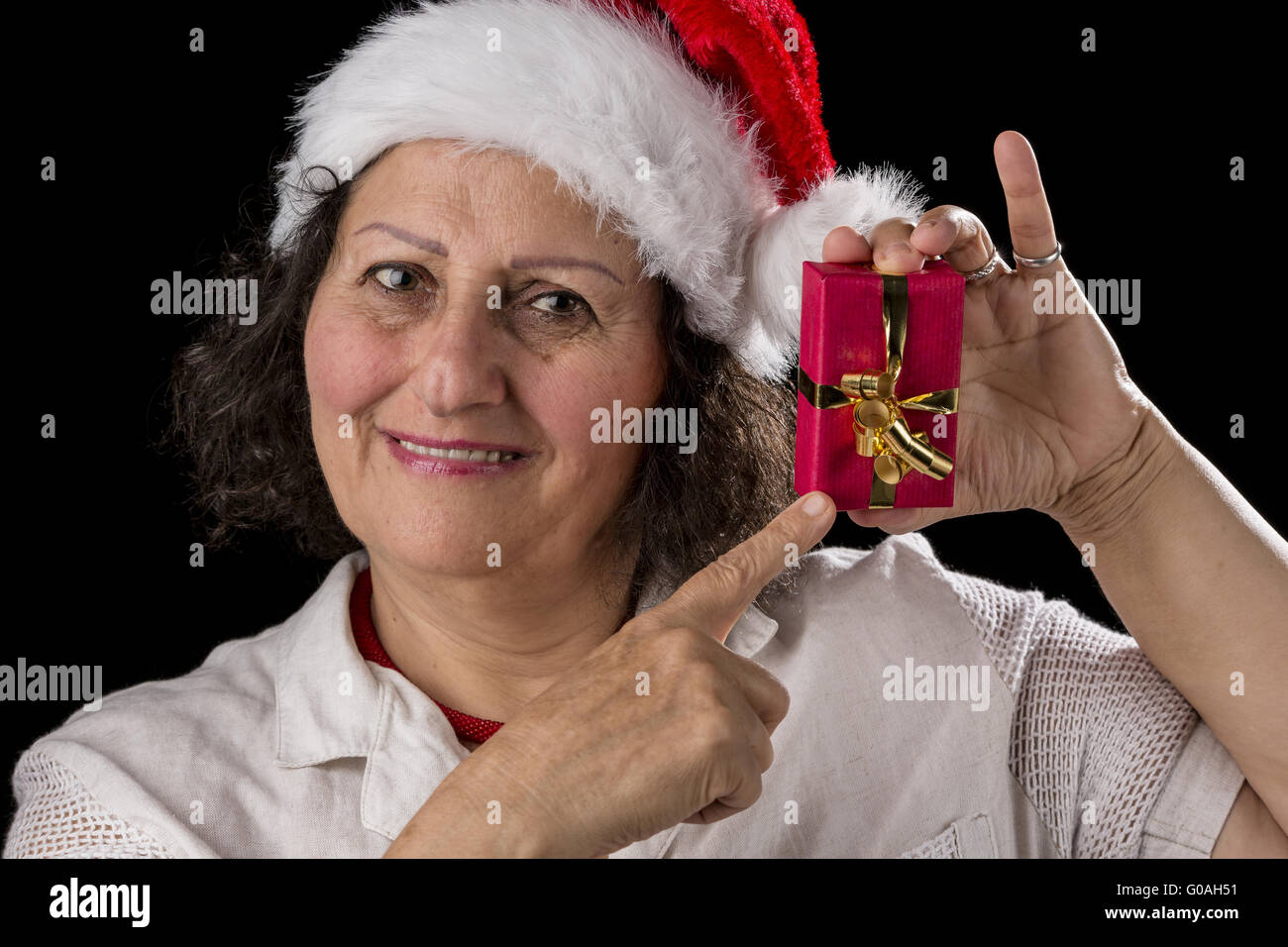 Smiling Aged Woman Holding and Pointing at Red Gif Stock Photo