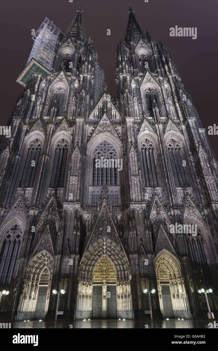 Gothic west facade of Cologne Cathedral at night. Stock Photo