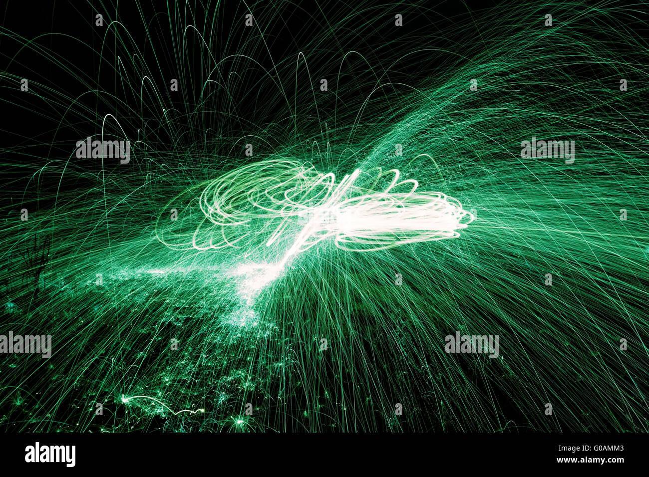 Showers of hot glowing sparks from spinning steel wool. Stock Photo