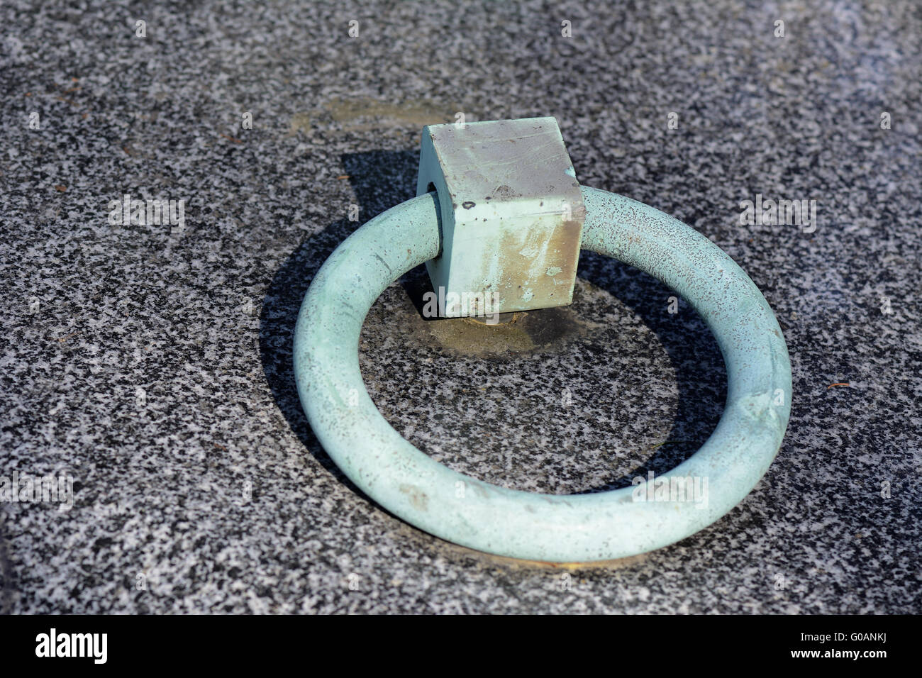 Ring of a grave stone with verdigris Stock Photo