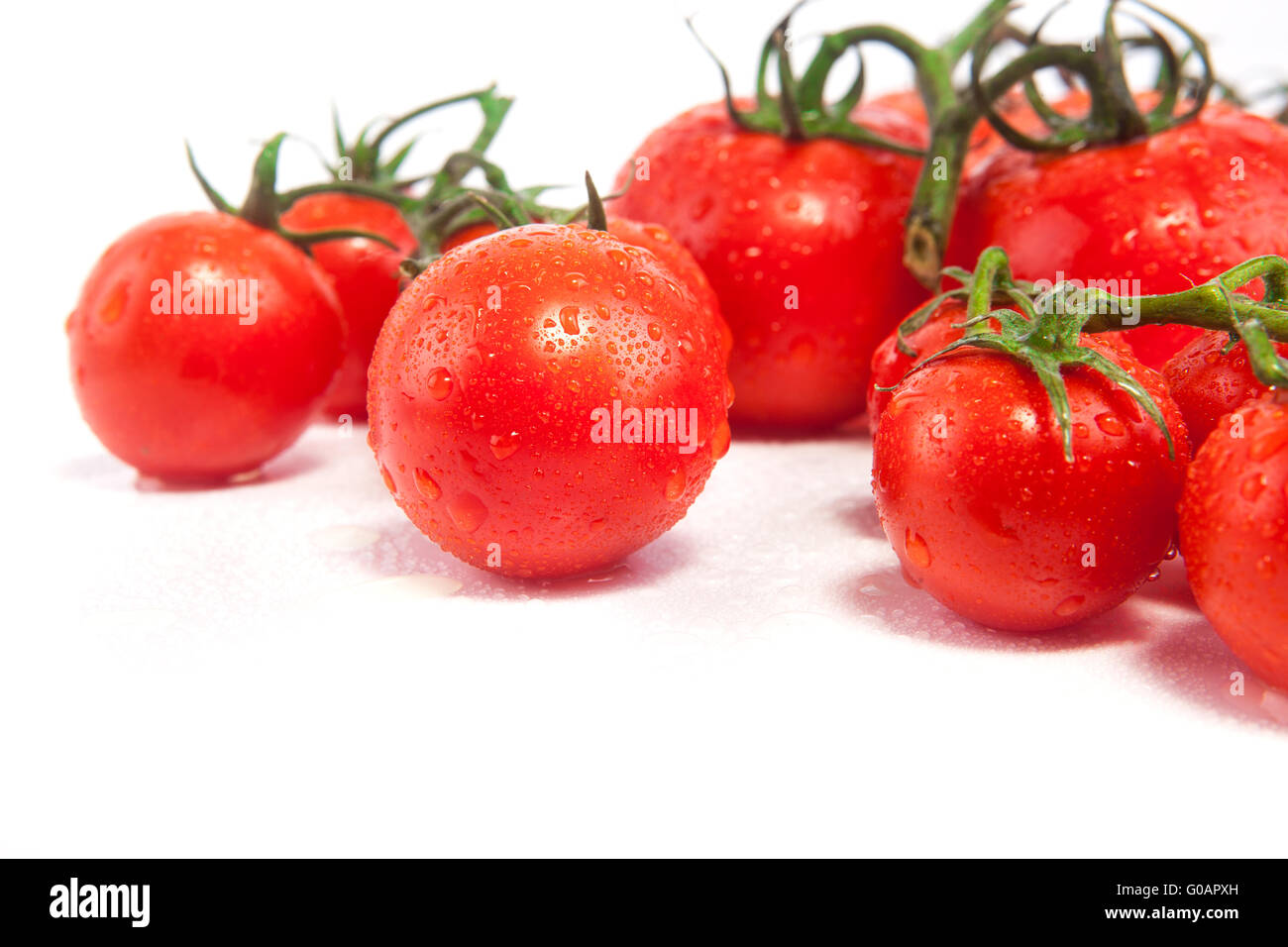 Fresh tomatoes isolated on white Stock Photo - Alamy