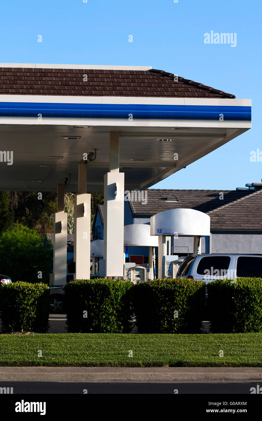 Gas Station with Green Shrubs Lawn Pumps Stock Photo