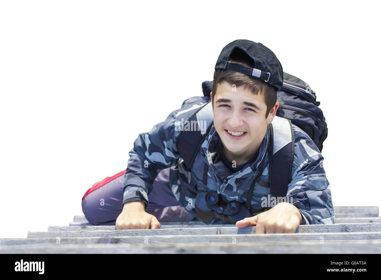 Boy climbing on wooden stairs on a white backgrou Stock Photo