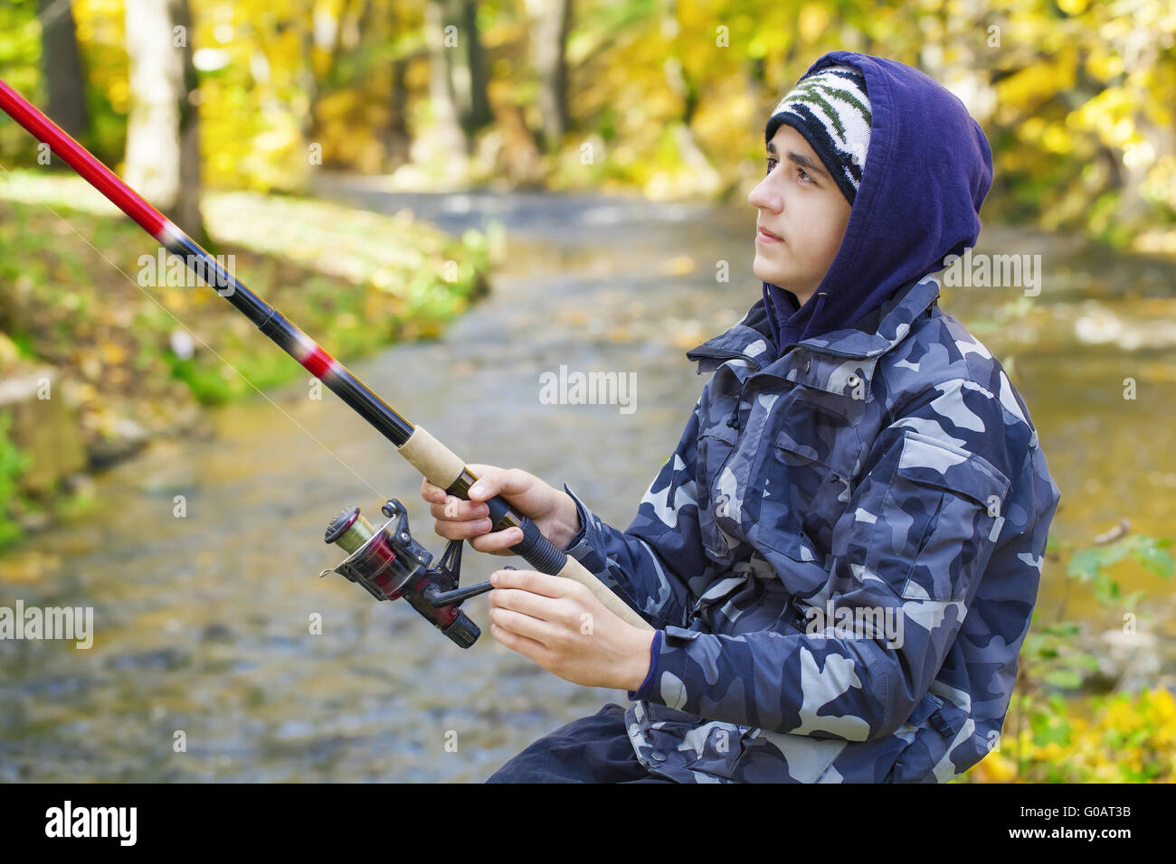 Boy fishing near river in hi-res stock photography and images - Alamy