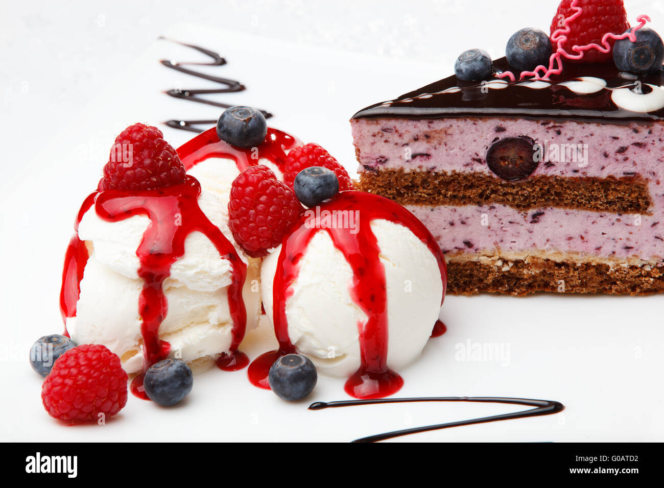 Vanilla icecream with berry coulis and fresh fruit Stock Photo