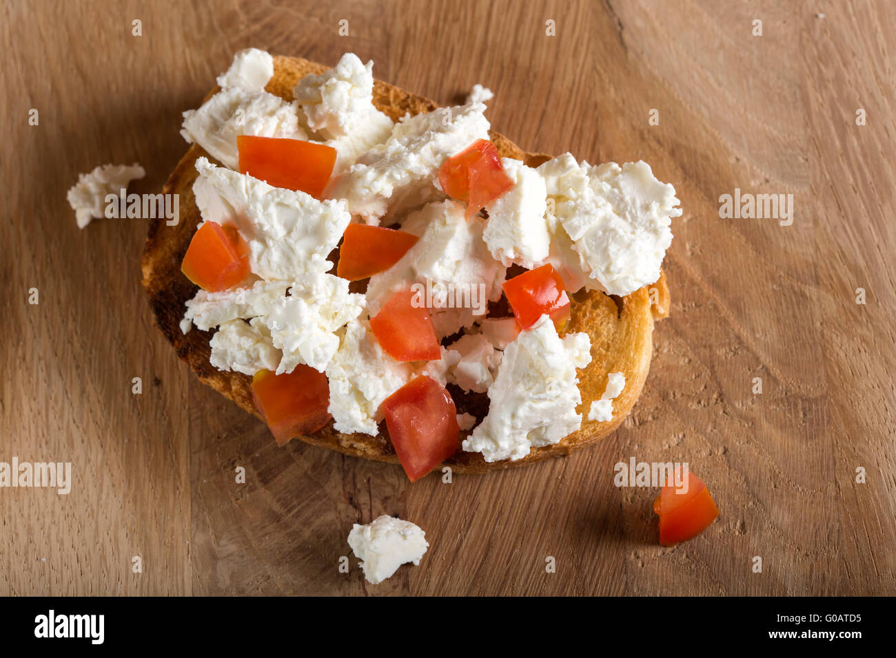 Italian bruschetta with tomato and cheese on wooden table Stock Photo