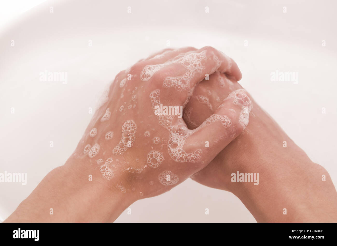 one hand washes the other Stock Photo