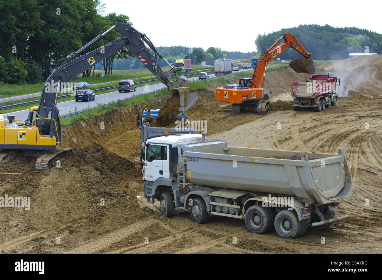 trucks and diggers at road construction in germany Stock Photo
